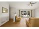 Bright living room with hardwood floors, large windows, and comfortable seating at 877 Old Farm Walk, Marietta, GA 30066