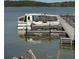 Pontoon boat docked at a wooden pier on a tranquil lake, ideal for leisure and recreation at 1000 Delta A15, Canton, GA 30114