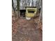 Exterior view of a single wide mobile home nestled among trees in a rustic setting at 1000 Delta A15, Canton, GA 30114