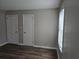 Neutral bedroom showcasing luxury vinyl flooring and two standard doors at 2468 Baxter Sw Rd, Atlanta, GA 30315