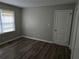 This bedroom features a window with blinds and luxury vinyl flooring at 2468 Baxter Sw Rd, Atlanta, GA 30315