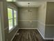 Cozy dining room with new floors, natural light, and classic chandelier at 2468 Baxter Sw Rd, Atlanta, GA 30315
