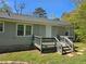 Back exterior view showcasing a cozy deck with steps and a grassy yard at 2468 Baxter Sw Rd, Atlanta, GA 30315