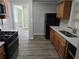 Functional kitchen featuring modern appliances, new countertop and wood cabinetry at 2468 Baxter Sw Rd, Atlanta, GA 30315