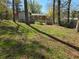 The backyard features grassy area with tree coverage and a partial fence line enclosing an outdoor space at 251 Banberry Se Dr, Atlanta, GA 30315