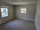 Bright bedroom featuring neutral carpet, fresh paint, and natural light from two windows at 251 Banberry Se Dr, Atlanta, GA 30315