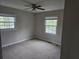 This cozy bedroom features neutral walls, carpet, and a ceiling fan with two windows for natural light at 251 Banberry Se Dr, Atlanta, GA 30315