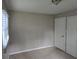 A minimalist bedroom includes neutral-toned walls, carpet, window blinds, and a double door closet for storage at 251 Banberry Se Dr, Atlanta, GA 30315