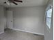 A simple bedroom with light walls, carpet, one window, and basic trim around the door and window at 251 Banberry Se Dr, Atlanta, GA 30315