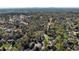 Sprawling neighborhood with mature trees and various houses, showcasing community layout with distant city skyline at 5780 Riverwood Dr, Sandy Springs, GA 30328