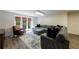 Basement living area with comfortable seating, ottoman, and access to the backyard at 5780 Riverwood Dr, Sandy Springs, GA 30328