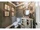 Elegant powder room featuring unique mirror vanity and stylish wall art at 5780 Riverwood Dr, Sandy Springs, GA 30328