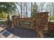 Elegant stone entrance to Rivershore Estates, with a beautifully crafted sign and landscaped surroundings at 5780 Riverwood Dr, Sandy Springs, GA 30328