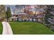 Charming single-Gathering home showcasing a lush green lawn, mature trees, and a welcoming front entrance at 5780 Riverwood Dr, Sandy Springs, GA 30328