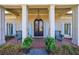 Inviting front porch with decorative columns, brick flooring, and charming seating area at 5780 Riverwood Dr, Sandy Springs, GA 30328
