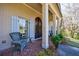 Comfortable front porch featuring brick flooring, classic columns, and a cozy seating area at 5780 Riverwood Dr, Sandy Springs, GA 30328