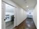 Long hallway with hardwood floors leading to a laundry room with storage at 5780 Riverwood Dr, Sandy Springs, GA 30328