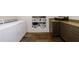 Well-organized laundry room with front load washer, dryer, cabinets and built-in storage shelves with laundry baskets at 5780 Riverwood Dr, Sandy Springs, GA 30328