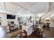 Cozy living room featuring a fireplace, staircase, and views of the landscaped backyard through large windows at 5780 Riverwood Dr, Sandy Springs, GA 30328