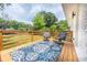 Outdoor wooden deck featuring an outdoor rug, outdoor seating, and a serene backyard view at 661 Inglewood Se Dr, Smyrna, GA 30080