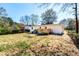 Backyard view showcasing the wooden deck, grassy area, and the home's white painted exterior at 661 Inglewood Se Dr, Smyrna, GA 30080