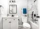 Bathroom featuring modern fixtures, a white vanity, and a shower-tub combination with marble tiling at 661 Inglewood Se Dr, Smyrna, GA 30080