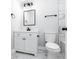 Clean bathroom with white marble floors and vanity, black fixtures, and decorative lighting at 661 Inglewood Se Dr, Smyrna, GA 30080