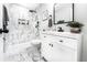 Modern bathroom featuring marble tiling, a sleek vanity, and a walk-in shower with matte black hardware at 661 Inglewood Se Dr, Smyrna, GA 30080