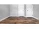 A freshly painted empty bedroom with two white doors, white trim, and wood-look flooring at 661 Inglewood Se Dr, Smyrna, GA 30080