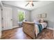 Cozy bedroom with natural light, wood floors, ceiling fan, and stylish decor at 661 Inglewood Se Dr, Smyrna, GA 30080