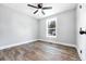 Cozy bedroom featuring wood-look floors, neutral paint, and a bright window at 661 Inglewood Se Dr, Smyrna, GA 30080