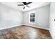 A freshly painted bedroom with updated windows, white trim, and wood-look flooring at 661 Inglewood Se Dr, Smyrna, GA 30080