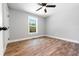A freshly painted bedroom with updated windows, white trim, and wood-look flooring at 661 Inglewood Se Dr, Smyrna, GA 30080