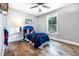 This cozy bedroom is bathed in natural light, highlighting the beautiful wood floors and stylish decor at 661 Inglewood Se Dr, Smyrna, GA 30080