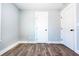 A clean, empty bedroom with fresh gray paint, white trim, and wood-look flooring at 661 Inglewood Se Dr, Smyrna, GA 30080