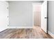 An empty bedroom shows the closet with wire shelving; fresh gray paint, white trim, and wood-look flooring at 661 Inglewood Se Dr, Smyrna, GA 30080
