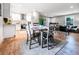 Bright dining room with a modern table, adjacent to a stylish kitchen and a comfortable living space at 661 Inglewood Se Dr, Smyrna, GA 30080