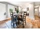 A dining area with a table set for four, offering a view of the kitchen and a door to the outside at 661 Inglewood Se Dr, Smyrna, GA 30080