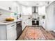 Bright kitchen with white cabinets, granite counters, stainless appliances, and modern fixtures at 661 Inglewood Se Dr, Smyrna, GA 30080