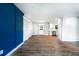 Open-concept living space with wood floors, white trim, and a navy blue accent wall at 661 Inglewood Se Dr, Smyrna, GA 30080