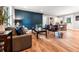 Spacious living room featuring a modern design, hard wood floors, and a stylish accent wall at 661 Inglewood Se Dr, Smyrna, GA 30080