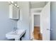 Traditional bathroom with a pedestal sink, mirrored medicine cabinet, and classic fixtures, showcasing a functional design at 561 Formwalt Sw St # 6, Atlanta, GA 30312