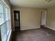 This carpeted bedroom features a window, with access to the bathroom and closet at 7508 Asbury Manor Dr, Lithonia, GA 30058