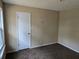 Neutral bedroom featuring wall-to-wall carpeting, and a white door and trim at 7508 Asbury Manor Dr, Lithonia, GA 30058