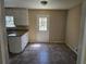 Cozy kitchen with granite countertops, tile flooring, and a window over the sink at 7508 Asbury Manor Dr, Lithonia, GA 30058