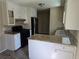 Well-equipped kitchen featuring granite countertops, black appliances, and plentiful storage at 7508 Asbury Manor Dr, Lithonia, GA 30058