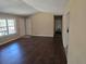 Open-concept living room featuring new flooring and access to the front door and hallway at 7508 Asbury Manor Dr, Lithonia, GA 30058