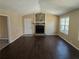 Spacious living room featuring a stone fireplace, new flooring, and abundant natural light at 7508 Asbury Manor Dr, Lithonia, GA 30058
