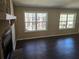 Bright living room showcasing a stone fireplace and large windows with wooded views at 7508 Asbury Manor Dr, Lithonia, GA 30058