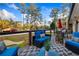 Well-furnished back deck features a geometric rug, comfortable seating, and views of the large yard at 994 Redbud Sw Ln, Atlanta, GA 30311